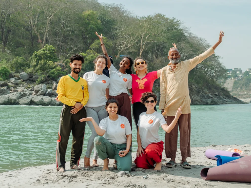 200 hour yoga teacher training group with their teacher on the river bank