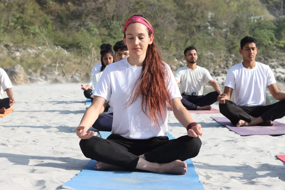Students meditating together on the banks of the Ganga