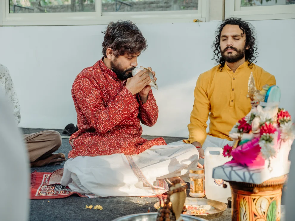 Priest blowing the conch during a traditional puja at Rishikesh Yog Kendra