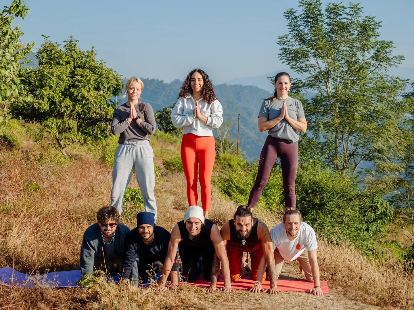 Graduating 300 hour yoga teacher training group on a hilltop above Rishikesh