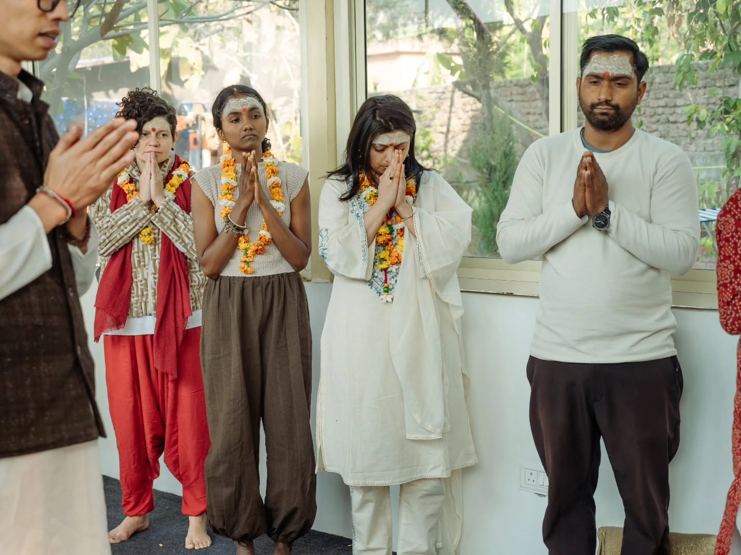 Students wearing marigold garlands during a certification ceremony at Rishikesh Yog Kendra