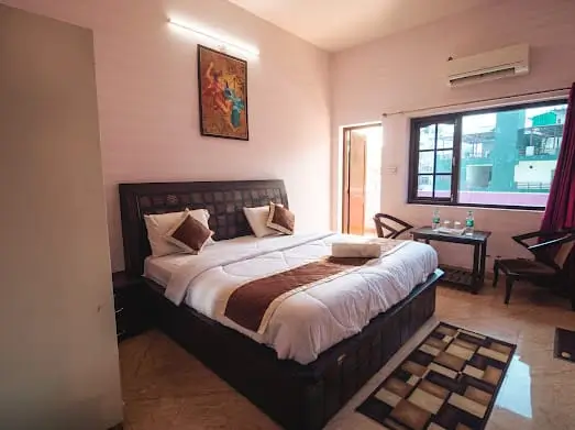 Room with exposed beams and a wooden floor