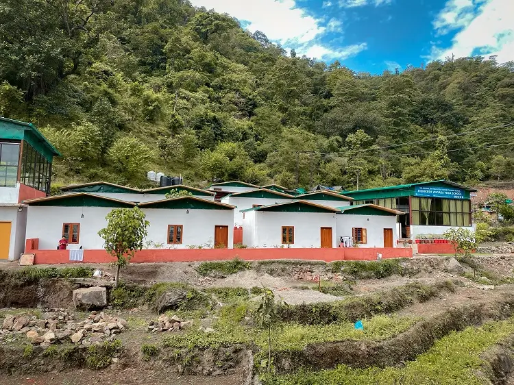 Rows of rooms below the forest at Rishikesh Yog Kendra
