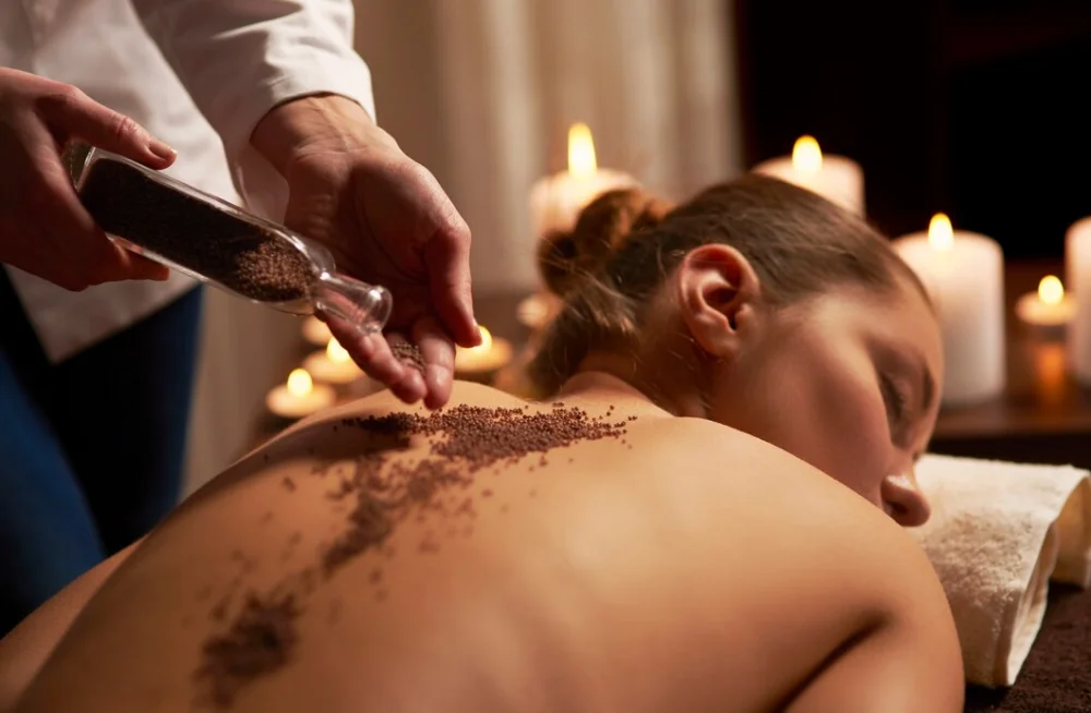 A therapist applying herbs during a Panchakarma treatment