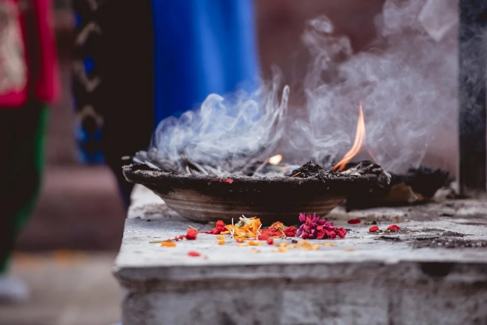 Sacred fire and flower offerings during an Ayurvedic ceremony