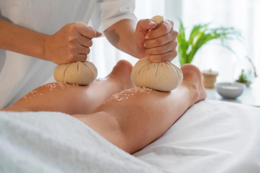 Warm herbal poultices used in a Panchakarma massage