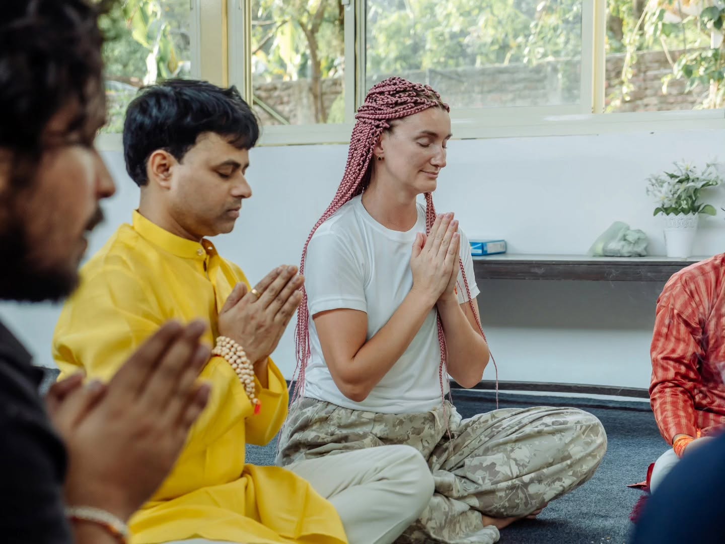 Students meditating in prayer during an Ayurveda class