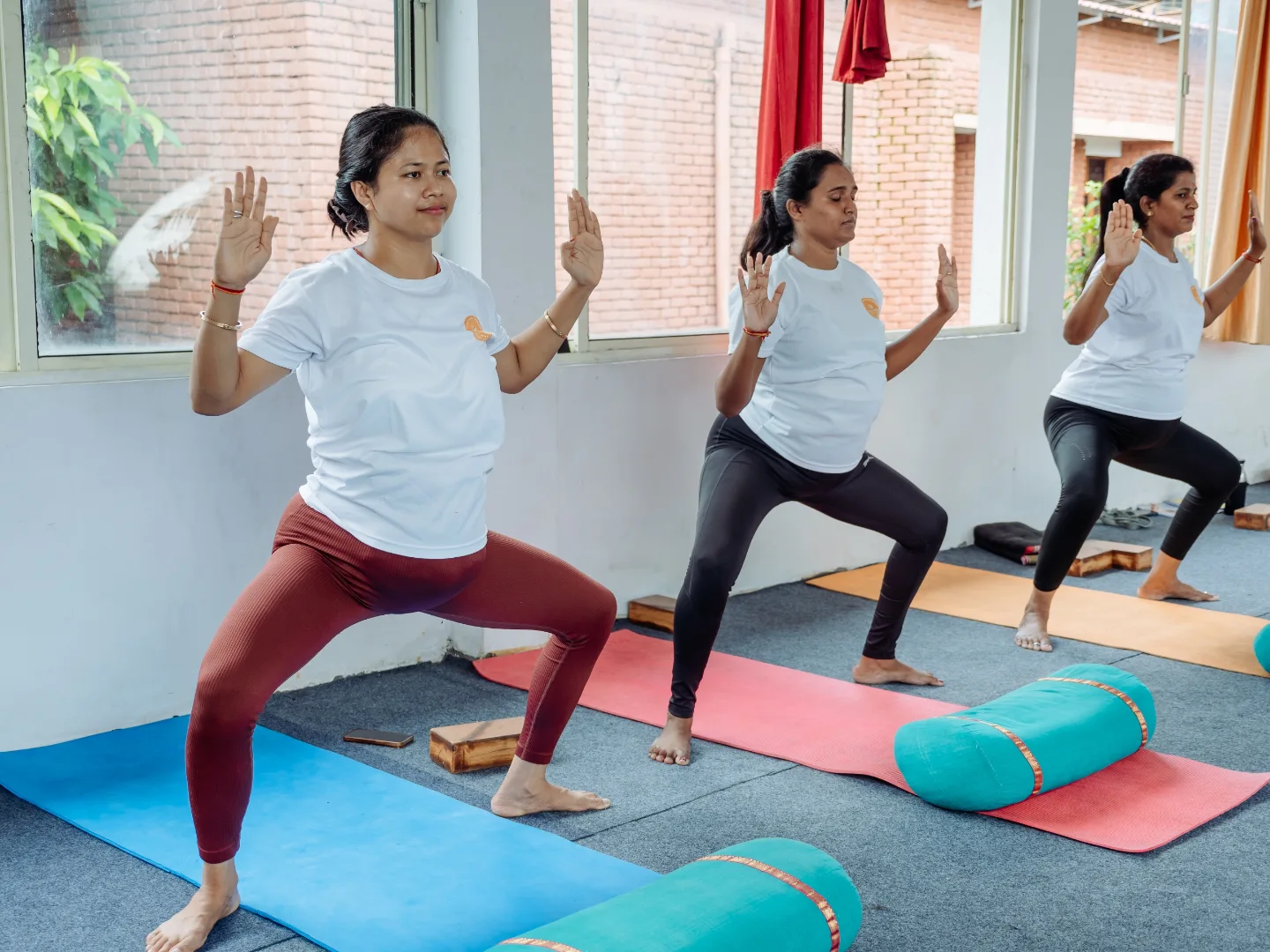 Prenatal yoga students practising goddess pose with an open stance