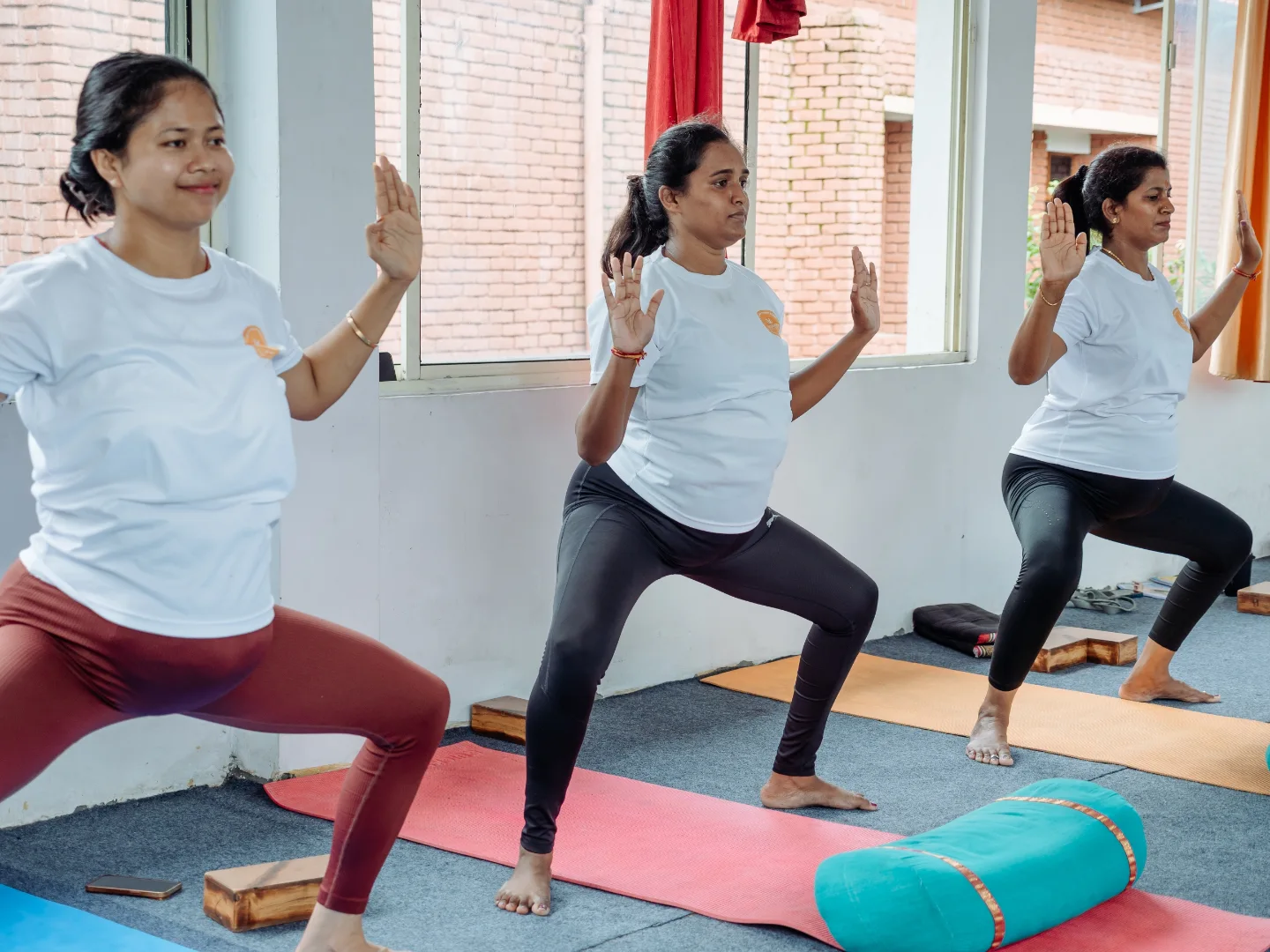 Three expecting mothers holding goddess pose side by side