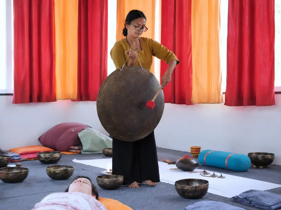 Gong bath in progress as students rest in savasana on the studio floor