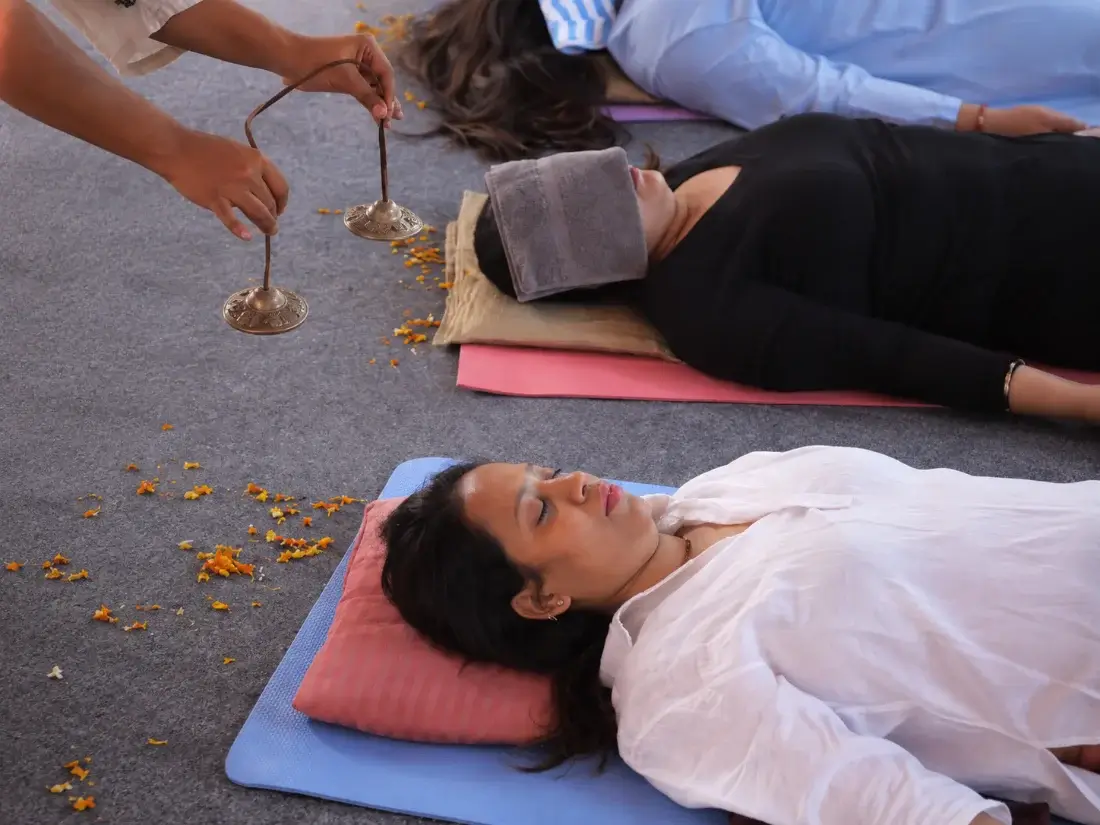 Tingsha cymbals sounded above students lying in deep relaxation