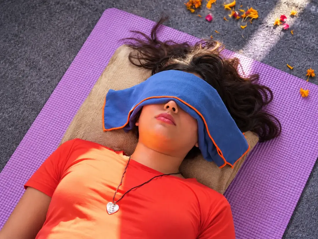 Student resting under an eye cover as the sound settles