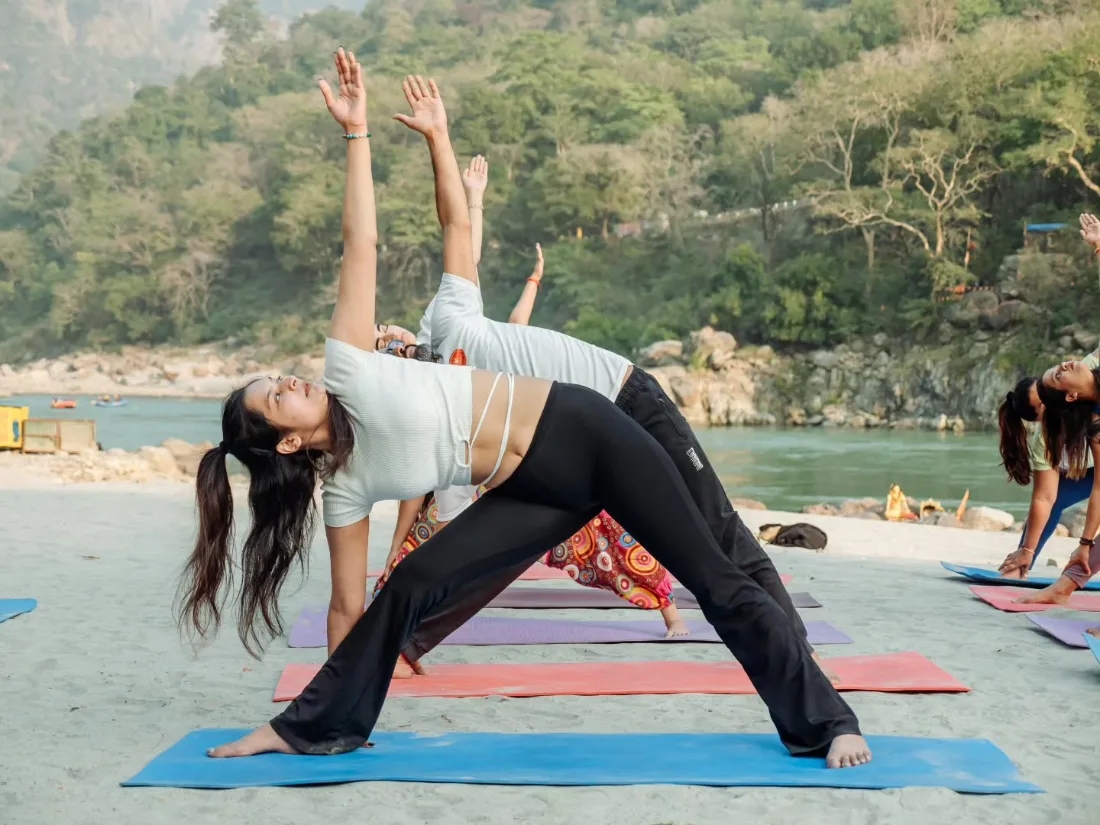 Asana practice on the banks of the Ganga during the Swadhyay yoga retreat