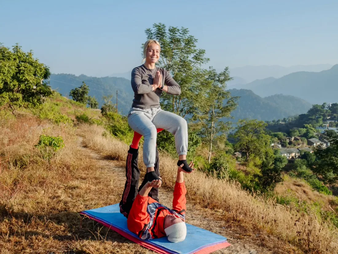 Acro-yoga partner pose practised during the 10 day yoga retreat in Rishikesh