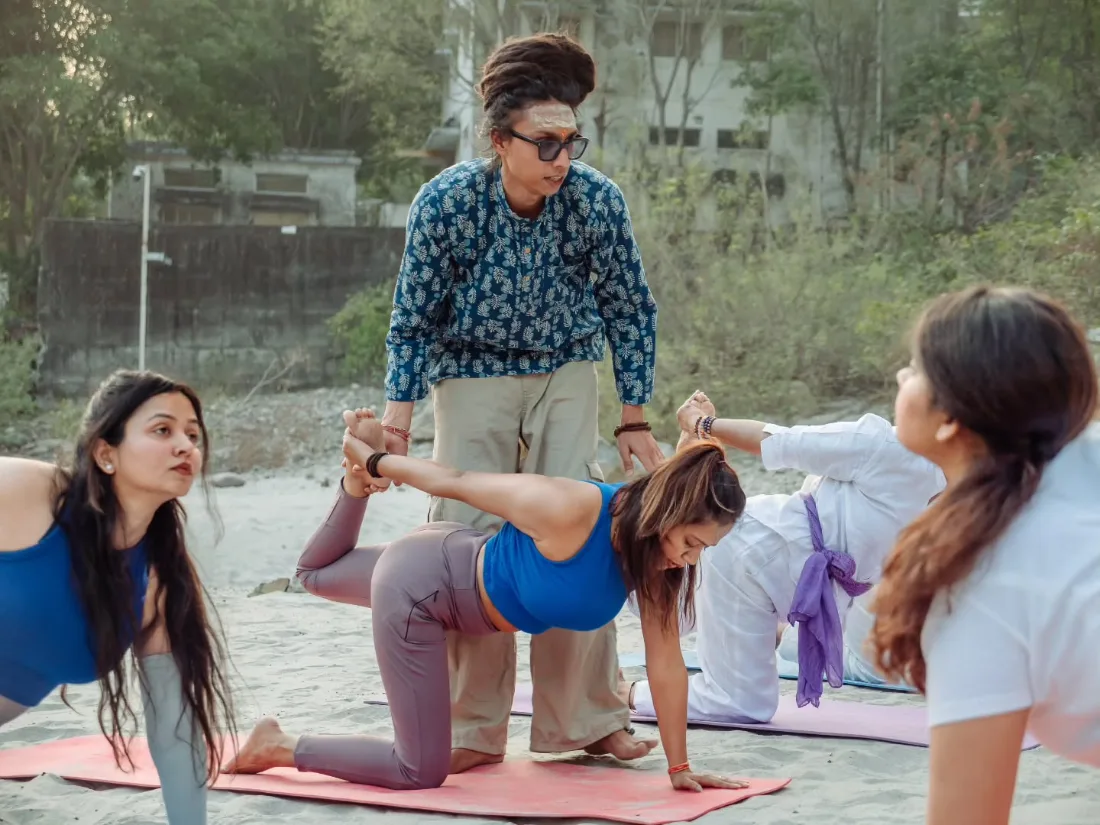 A teacher guiding a student through a supported stretch