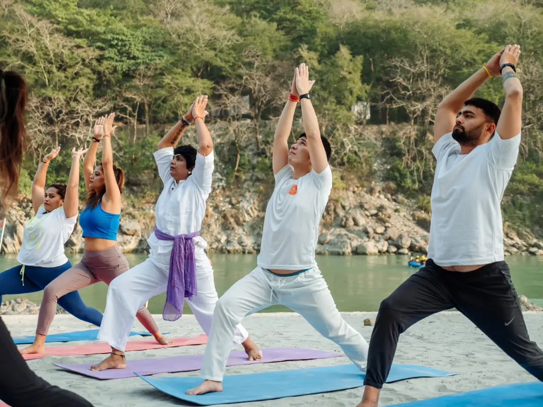 Group yoga session by the Ganga during the retreat