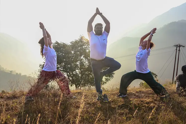 Practising yoga on the banks of the Ganga during the Vedic yoga retreat