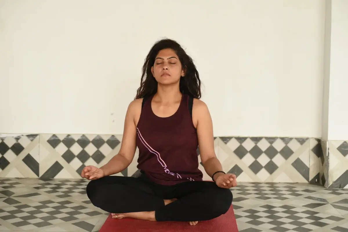 Student seated in quiet meditation during the training