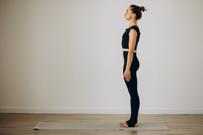 Woman practice Tadasana during Teacher Training course